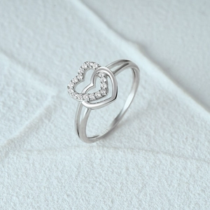 Macro shot of S925 sterling silver ring showing double heart design and sparkling diamonds