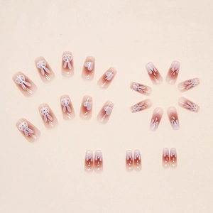 Sweet pink gradient press-on nails with cute bunny and heart patterns for a soft style