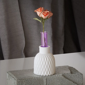 Modern white wave texture vase mold with a purple glass insert on a stone surface
