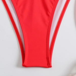 Macro view of solid red bikini bottom showing high-quality double-needle stitching detail