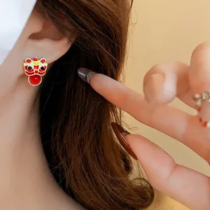 Red and white lion dance enamel earrings with bead detail and golden metal finish