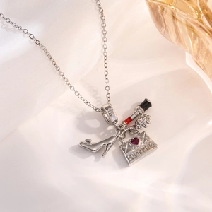 Detailed macro view of silver charms featuring a high heel, lipstick, and shopping bag