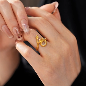 Detailed view of gold snake ring featuring micro-paved zircons and adjustable open band