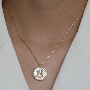 18k gold plated brass necklace with mother of pearl shell dolphin pendant on model
