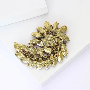 Detail view of the secure pin clasp on the vintage gold alloy rhinestone brooch