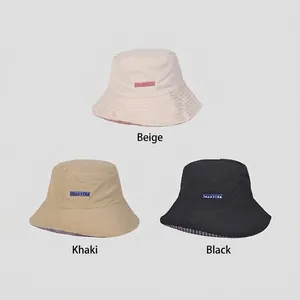 Three minimalist cotton bucket hats in beige, khaki, and black with Senorica embroidery