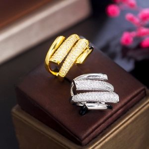 Elegant gold and silver floral crown rings with zircon inlays on a jewelry box