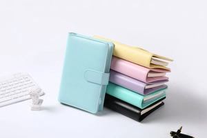 Pile of colorful A6 Macaron PU leather loose-leaf notebooks with a round buckle closure