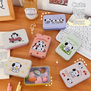 Assorted colorful tin storage boxes with cute cartoon dog prints on an office desk