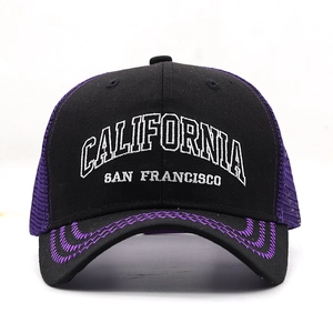 Detail of white California embroidery and purple mesh on a black trucker baseball cap