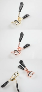 Close-up of portable stainless steel eyelash curlers in gold and rose gold finishes