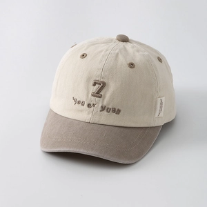 Close-up of contrast color cotton kids baseball cap with 3D embroidery and twill texture