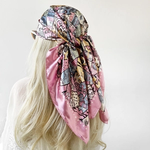 Detail of pink satin scarf with cartoon cat print worn as a stylish headscarf