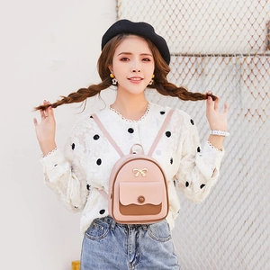 Chic pink and brown mini backpack for women featuring a gold bow accent and PU leather finish