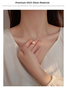 Close-up of S925 sterling silver necklace with a lustrous pink pearl pendant on model