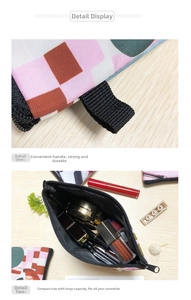 Detail of the polyester dumpling makeup bag with letter print and black carry handle