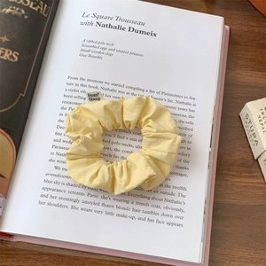 Detail of yellow cotton scrunchie with From Sheep label on a vintage book