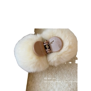 Cute beige plush pom pom hair claw clip with brown plastic grip for women's hairstyles