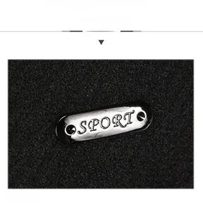 Detailed macro view of the silver metal Sport plaque on a black knitted winter baseball cap