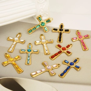 Colorful stainless steel cross pendants with inlaid rhinestones on a soft gray fabric