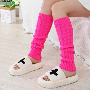 Detail of rose pink cable knit leg warmers with fuzzy slippers for winter comfort