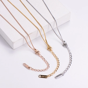 Close-up of 18KGP snake chains in rose gold, gold, and silver finishes with lobster clasp