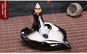 Detail of leaf-shaped ceramic backflow incense burner with dual-use cone and stick holder