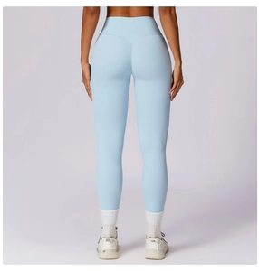 Close-up of light blue high-waist yoga pants featuring V-shaped scrunch butt seam