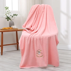 Detail of pink coral fleece bath towel with embroidered moon rabbit and text