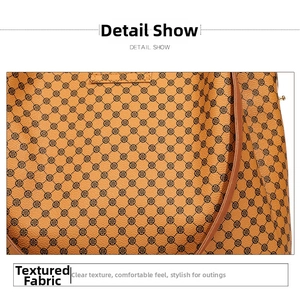 Detail show of brown synthetic leather bag featuring clover print and golden hardware