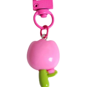 Close-up of pink tulip keychain pendant with green leaves and matching metal lobster clasp