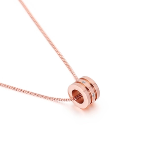 Elegant rose gold hourglass pendant necklace with sparkling inlaid crystals on white background