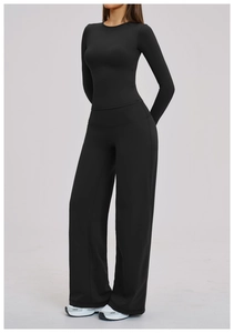 Detail view of high-elastic black long-sleeve top and high-waist wide-leg yoga pants