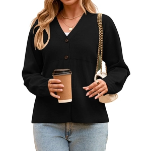 Detail of black V-neck cardigan featuring ribbed knit texture and stylish button closure
