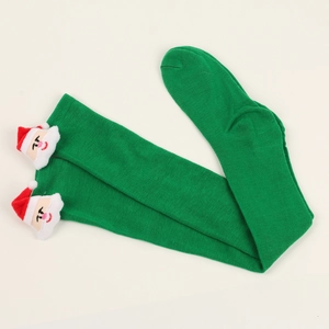 Detail of green knitted Christmas thigh high socks with 3D Santa Claus plush figures