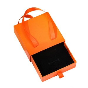 Orange cardboard drawer jewelry box with satin ribbon handle and black foam insert