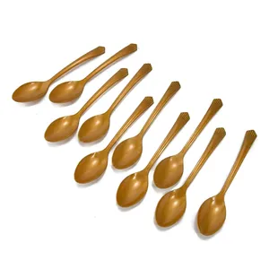 Set of 10 shiny gold plastic spoons with elegant fan-shaped handles for party decor