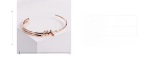 Detail view of rose gold knotted cuff bracelet showing the 57mm inner diameter dimensions