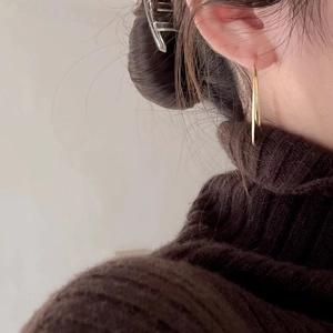Minimalist large golden hoop earrings for women shown on a model with elegant style