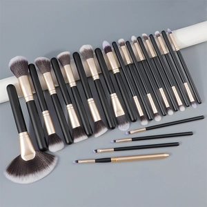 Macro detail of professional 24-piece black and gold matte makeup brush set with fiber bristles