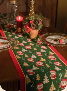 Detail of Christmas table runner with Santa motifs and jacquard fabric on a festive table