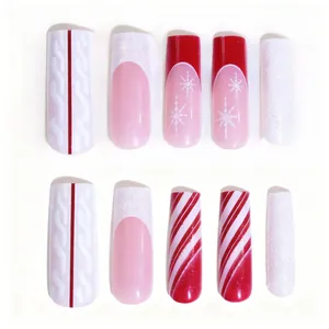 Detail of Christmas press-on nails with 3D sweater texture, snowflakes and glitter