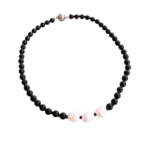 Ethnic beaded necklace with black glass beads and three white baroque pearl pendants