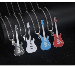Detail showing four colors of guitar pendant necklaces with enamel finish on metal chain