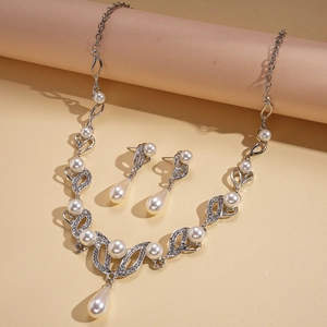 Elegant two-piece jewelry set with silver leaf design, faux pearls and crystals