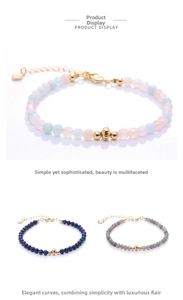 Detail of beaded bracelets with natural gemstones and gold-plated heart charms