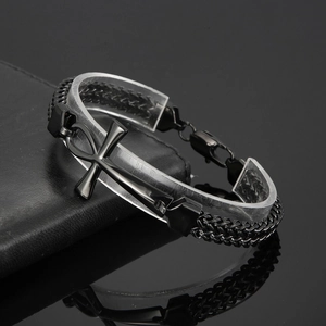 Macro detail of black Ankh cross pendant on a double-row braided stainless steel chain