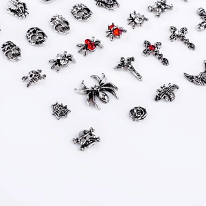 Gothic silver nail art charms including skulls, crosses and spiders with red rhinestones