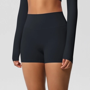 Detail of high-waist black fitness shorts showing matte elastic fabric and sculpting fit