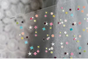 Macro shot of colorful geometric nail stickers with matte finish and ultra-thin adhesive base